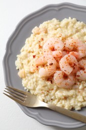 Photo of Delicious risotto with shrimps and cheese on white table, top view