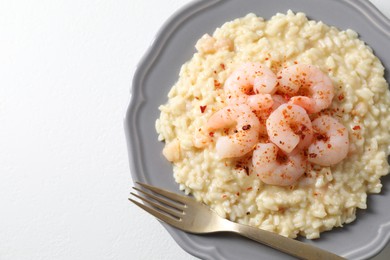 Photo of Delicious risotto with shrimps and cheese on white table, top view