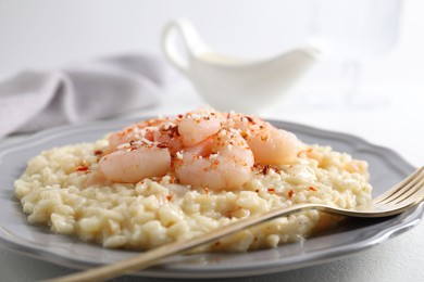 Photo of Delicious risotto with shrimps and cheese on table, closeup