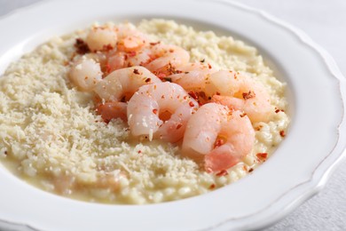 Photo of Delicious risotto with shrimps and cheese on table, closeup