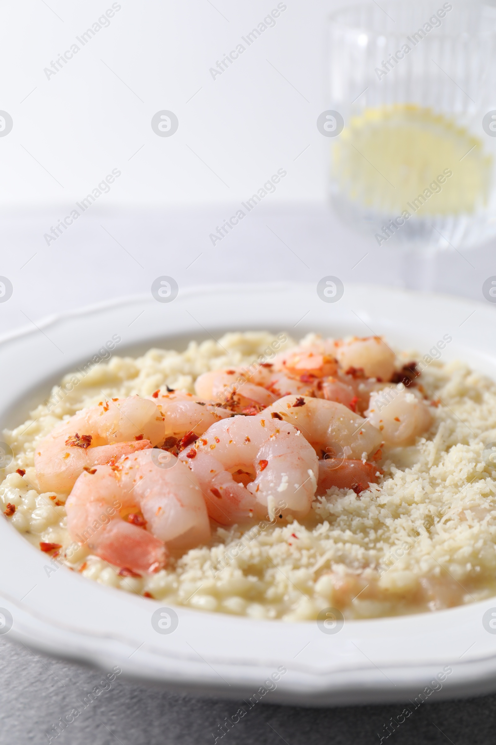 Photo of Delicious risotto with shrimps and cheese on table, closeup