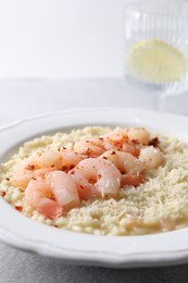 Photo of Delicious risotto with shrimps and cheese on table, closeup