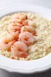 Photo of Delicious risotto with shrimps and cheese on table, closeup