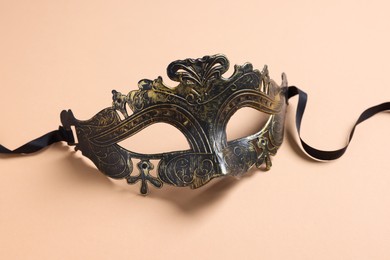 Photo of One beautiful carnival mask on beige background