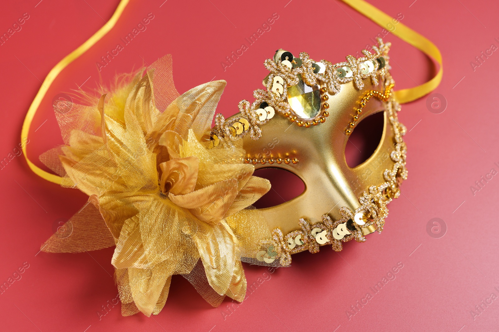 Photo of One beautiful carnival mask on red background