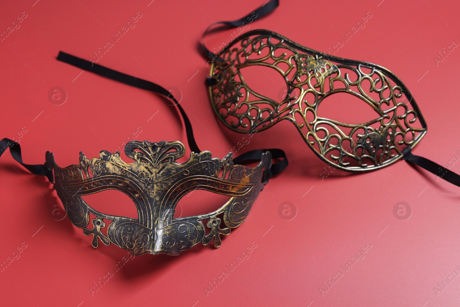 Photo of Two beautiful carnival masks on red background