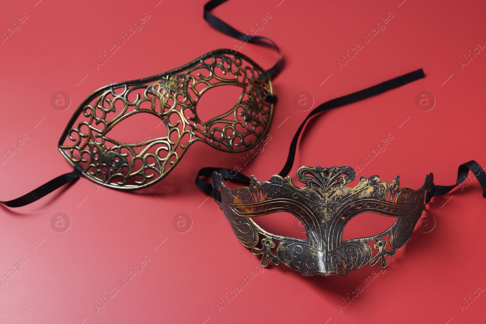 Photo of Two beautiful carnival masks on red background