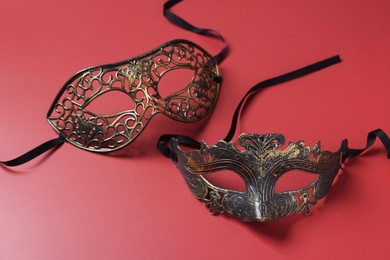 Photo of Two beautiful carnival masks on red background