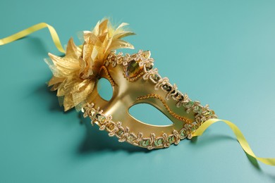 Photo of One beautiful carnival mask on teal background