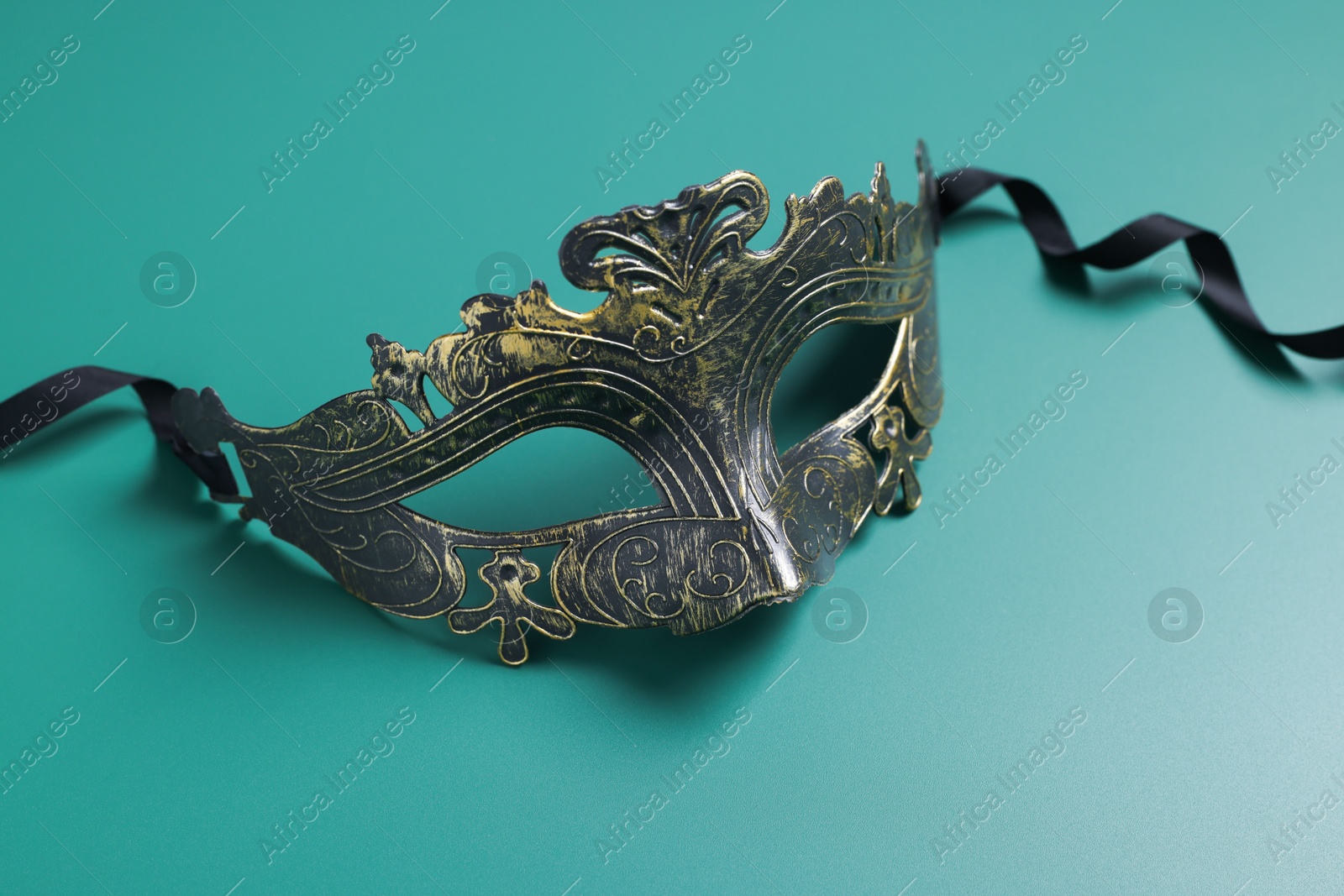 Photo of One beautiful carnival mask on teal background