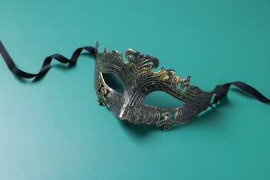 Photo of One beautiful carnival mask on teal background