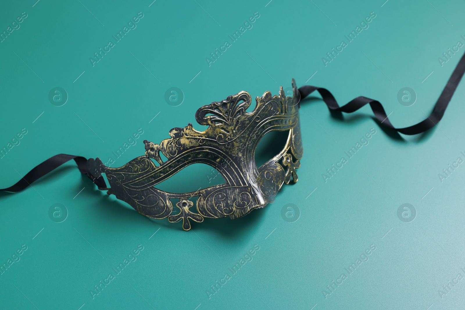 Photo of One beautiful carnival mask on teal background