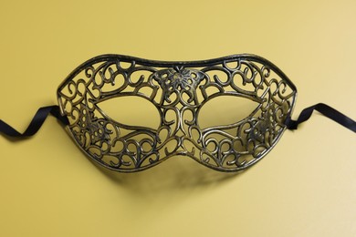 One beautiful carnival mask on yellow background