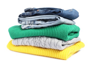 Photo of Stack of sweaters and jeans isolated on white