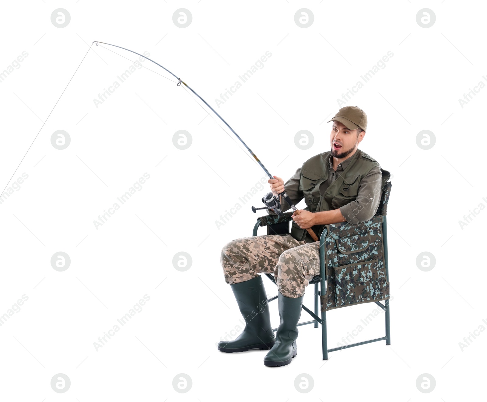 Photo of Emotional fisherman with rod fishing on chair against white background