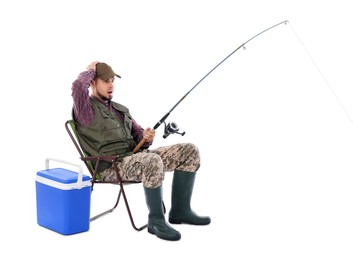 Emotional fisherman with rod and cooler box fishing on chair against white background