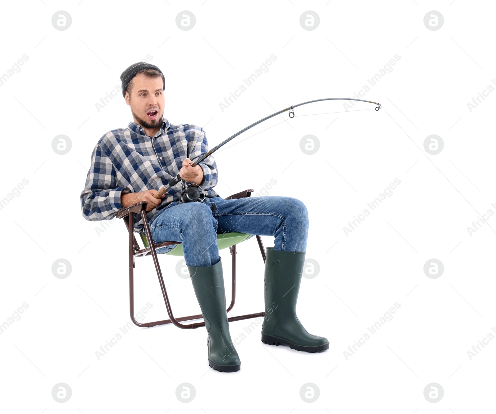 Photo of Emotional fisherman with rod fishing on chair against white background