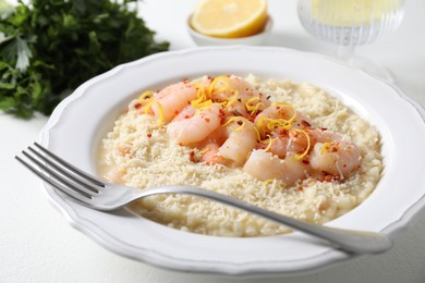 Photo of Delicious risotto with shrimps and cheese on white table, closeup