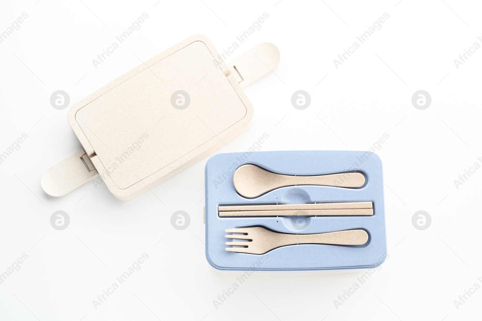 Photo of Plastic lid from lunch box and holder with cutlery isolated on white, top view