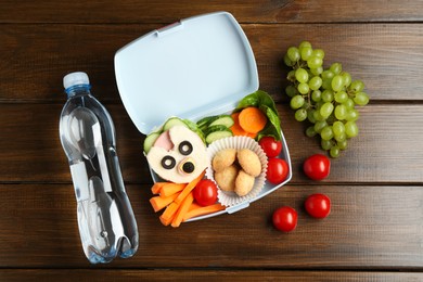 Photo of Lunch box with sandwich, fresh vegetables, cookies, grapes and bottle of water on wooden table, flat lay