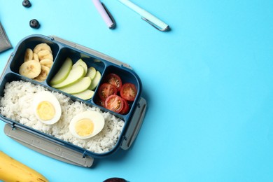 Photo of Lunch box with snacks and pens on light blue background, flat lay. Space for text