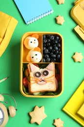 Photo of Flat lay composition with lunch box and snacks on green table