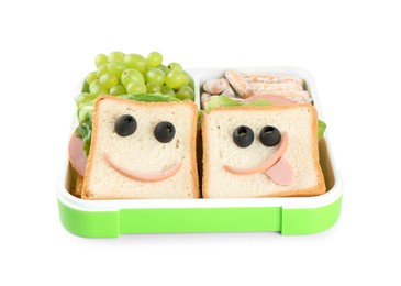 Photo of Sandwiches with smiley faces, grapes and cookies in lunch box isolated on white