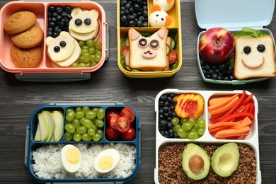 Photo of Lunch boxes with different snacks on wooden table, flat lay