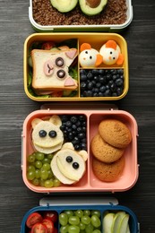 Photo of Lunch boxes with different snacks on wooden table, flat lay