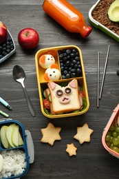 Photo of Lunch boxes with different snacks, bottle of juice and cutlery on wooden table, flat lay