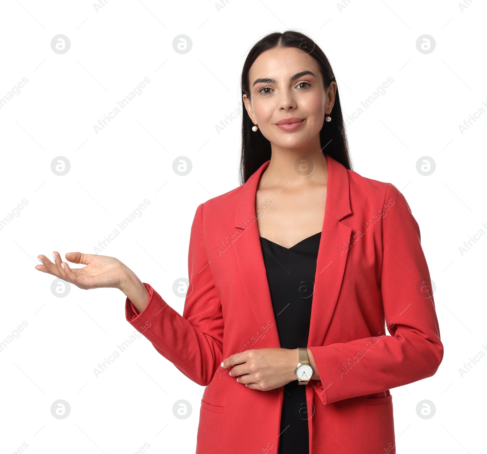 Photo of Beautiful woman in red jacket and black dress showing something on white background