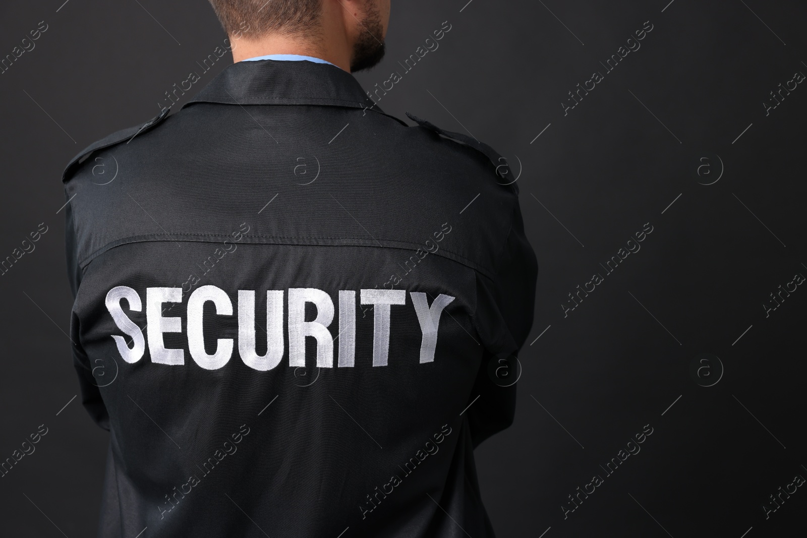 Photo of Security guard in uniform on black background, closeup