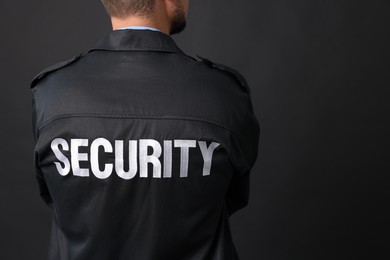 Security guard in uniform on black background, closeup