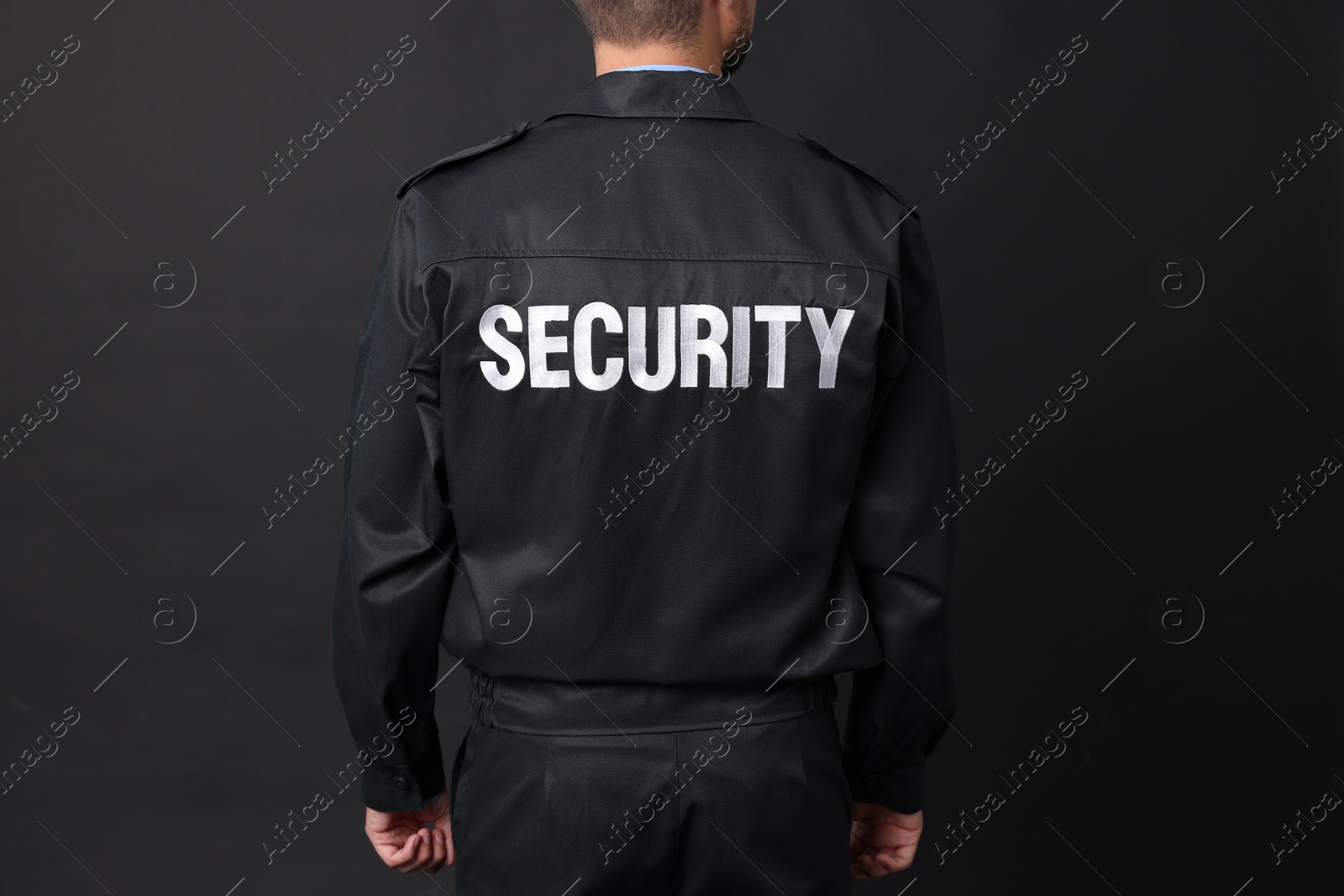 Photo of Security guard in uniform on black background, closeup