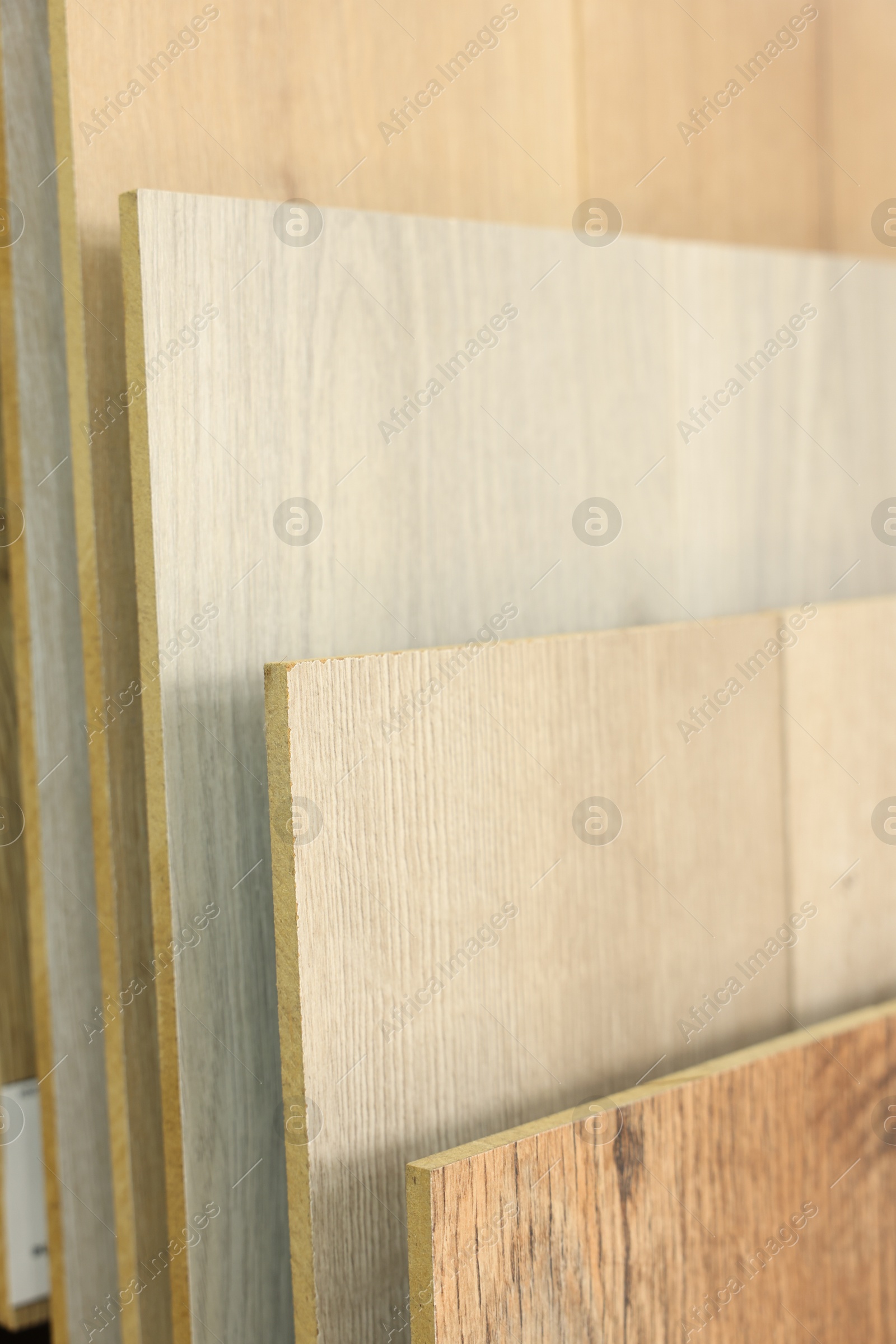 Photo of Many different samples of wooden flooring in store, closeup