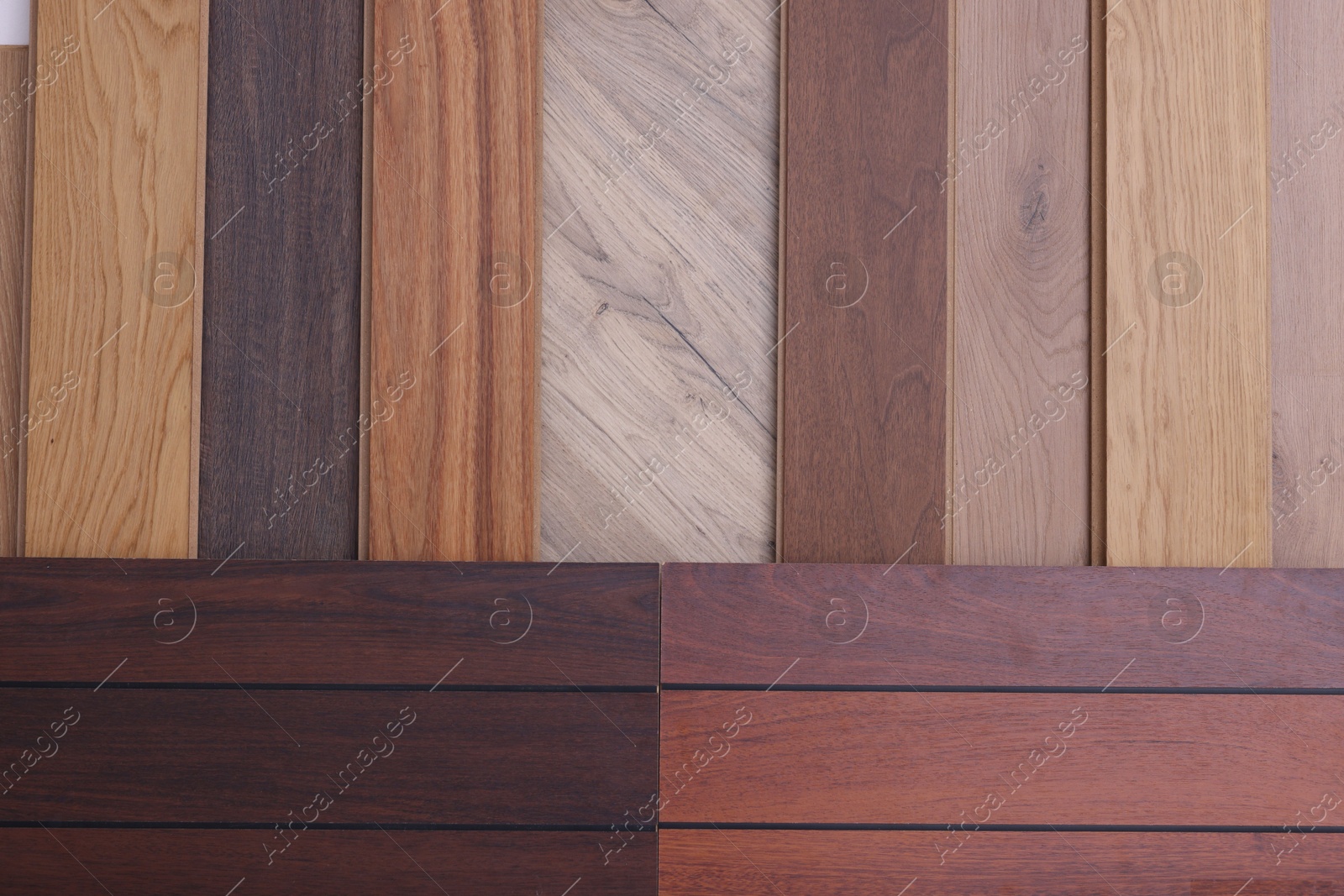 Photo of Many different samples of wooden flooring as background, top view