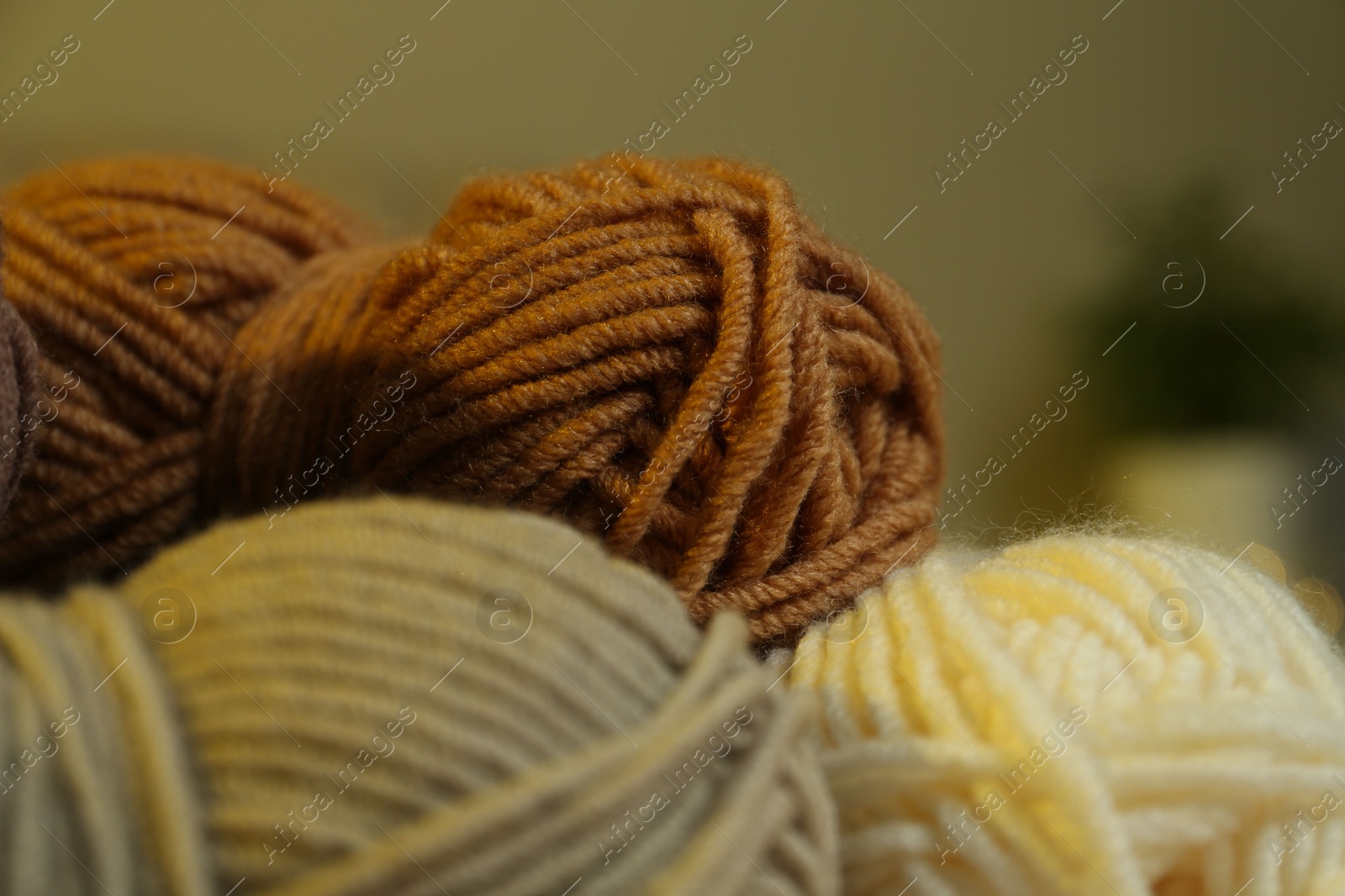 Photo of Skeins of soft yarn on blurred background, closeup. Knitting material