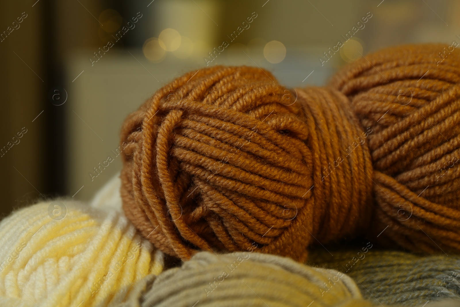 Photo of Skeins of soft yarn on blurred background, closeup. Knitting material