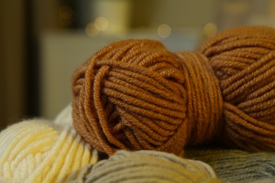 Photo of Skeins of soft yarn on blurred background, closeup. Knitting material