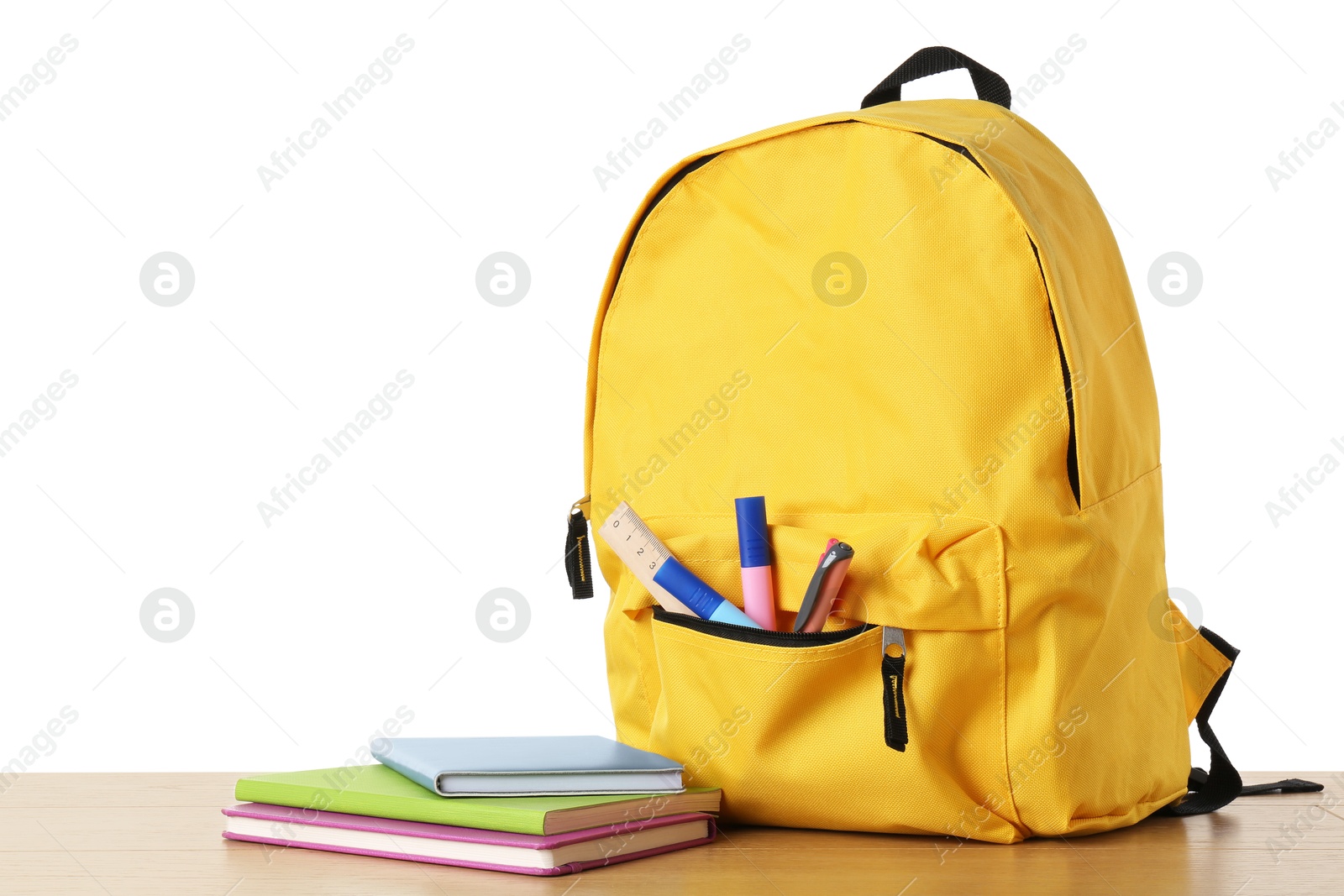 Photo of Backpack with different school stationery on wooden table against white background