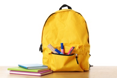 Photo of Backpack with different school stationery on wooden table against white background