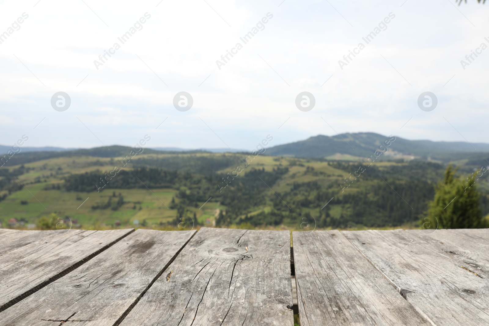 Photo of Empty wooden surface in mountains. Space for text