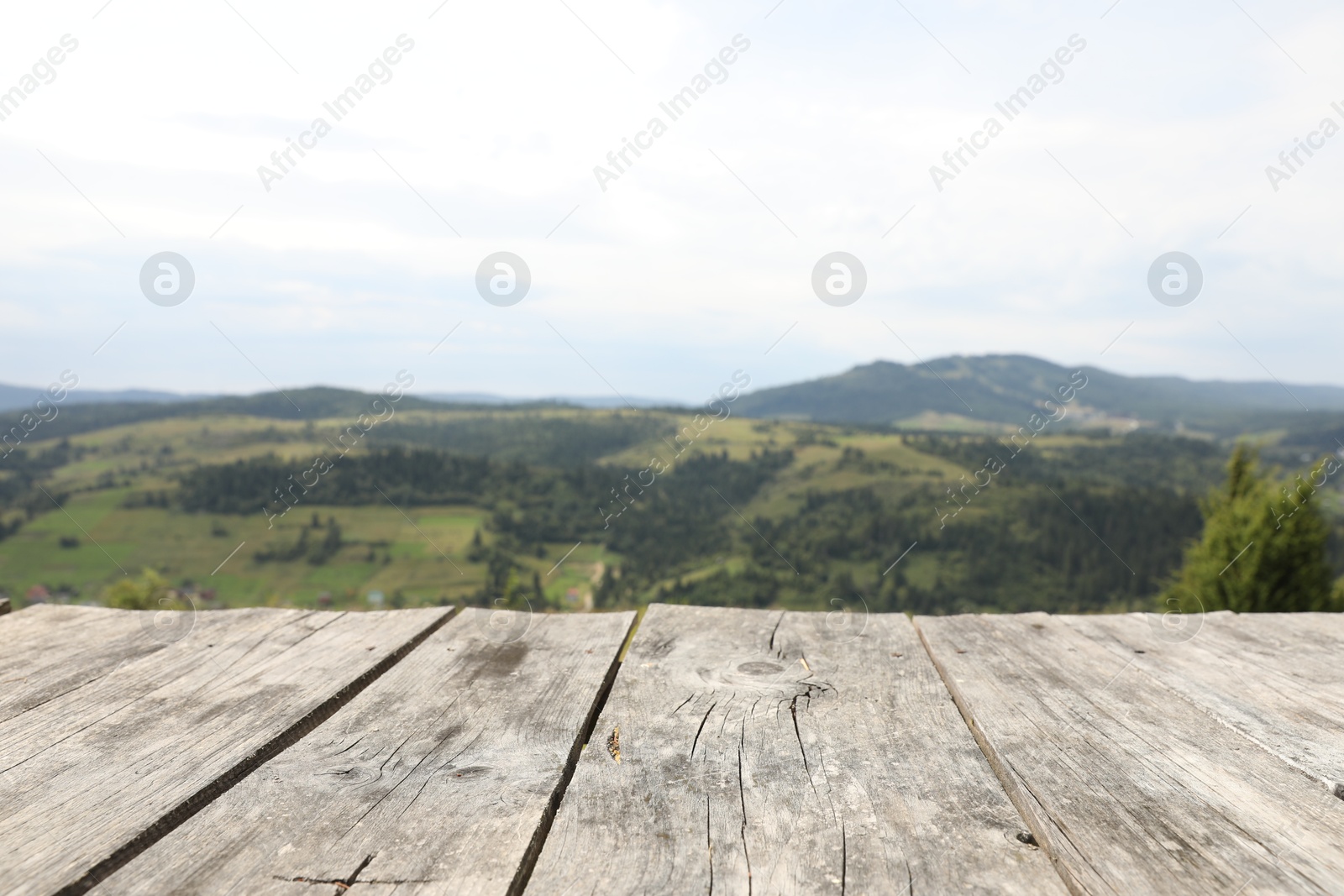 Photo of Empty wooden surface in mountains. Space for text