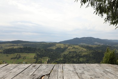 Photo of Empty wooden surface in mountains. Space for text