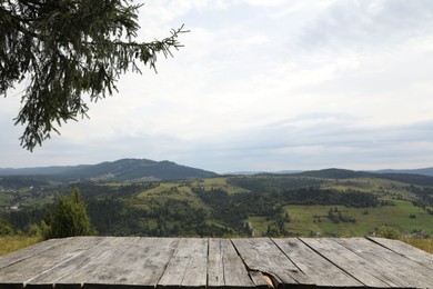 Photo of Empty wooden surface in mountains. Space for text