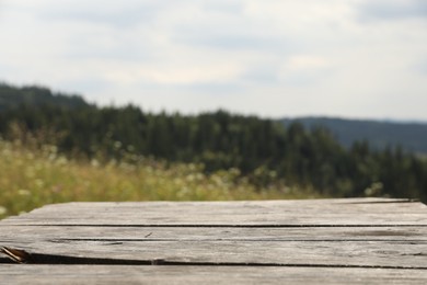 Photo of Empty wooden surface in mountains. Space for text