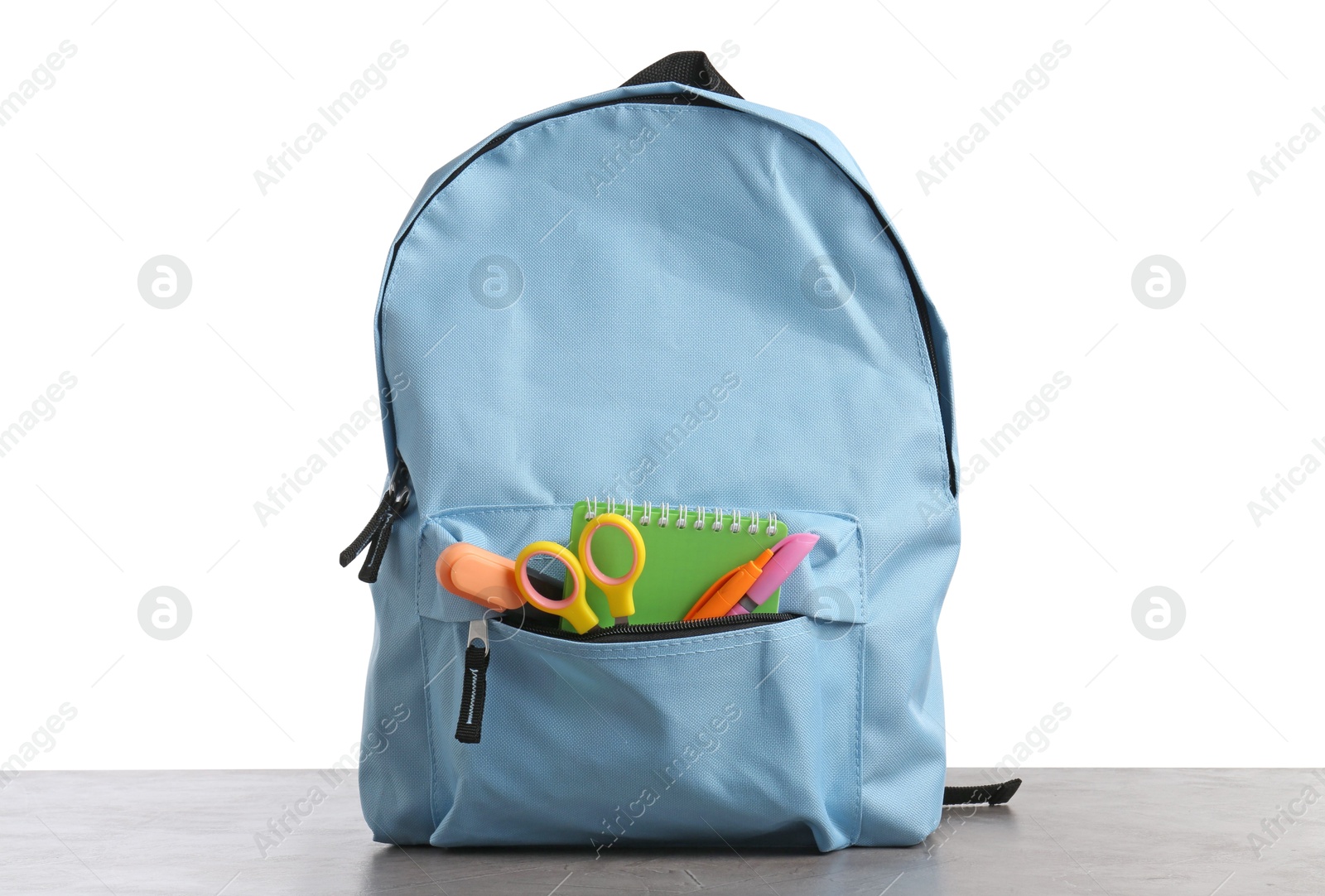 Photo of Backpack with different school stationery on gray textured table against white background