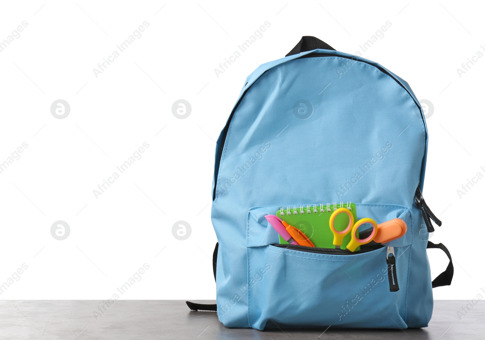 Photo of Backpack with different school stationery on gray textured table against white background, space for text