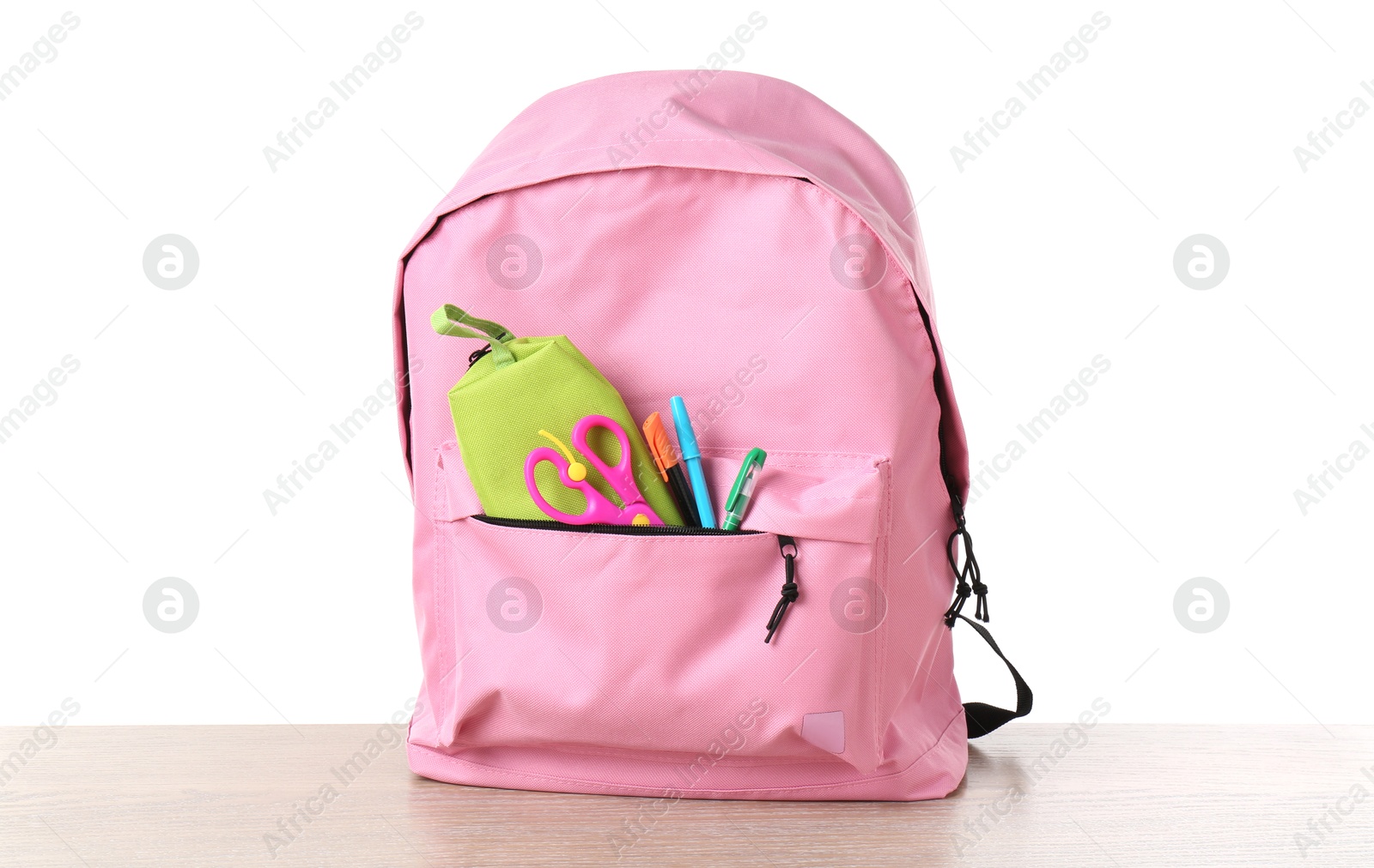 Photo of Backpack with different school stationery on wooden table against white background