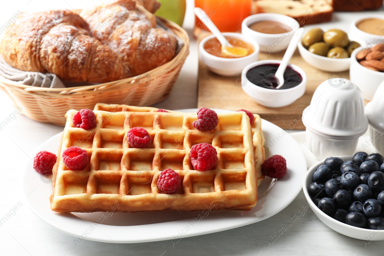 Photo of Different meals served for breakfast on white table, closeup. Buffet menu